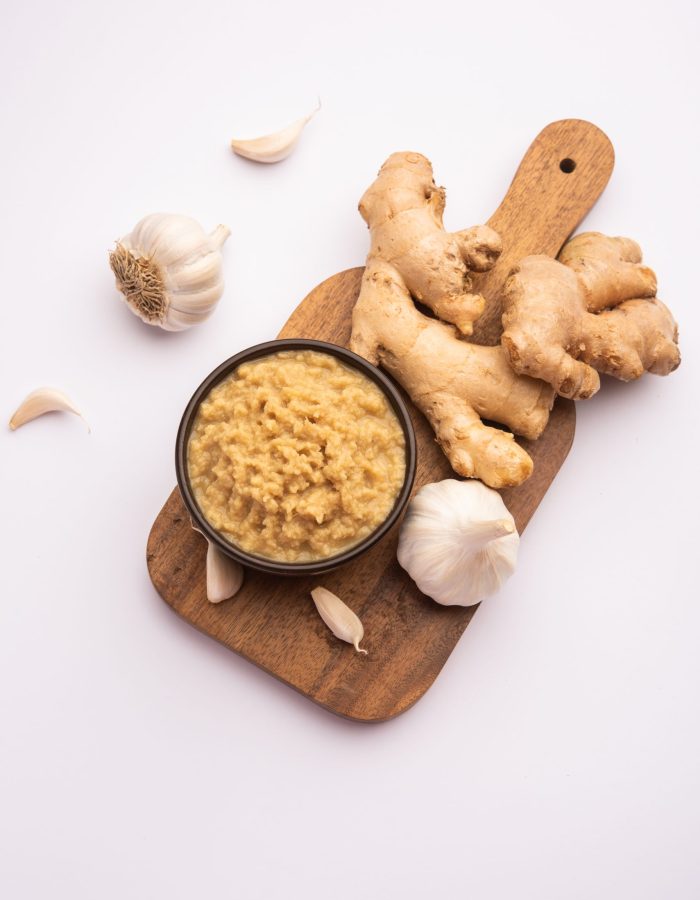 Fresh Ginger and Garlic paste or Adrak Lahsun puree in a ceramic bowl. Selective focus